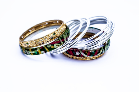 Close up of luxurious silver and gold bangles with diamonds on it isolated on white.の写真素材
