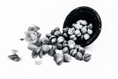 Ginjua or gingua or chick peas or chick pods or Egyptian beans in a clay bowl isolated on white.の写真素材