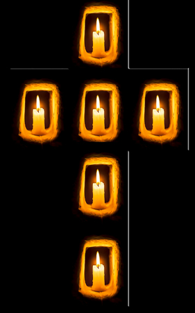 Cross forming of candles isolated on black.の写真素材