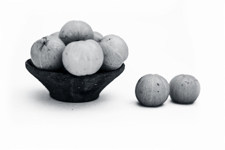 Close up of raw fresh organic popular Indian & Asian fruit isolated on white i.e. Indian gooseberry or Amla or Phyllanthus emblica  or emblic  or emblic myrobalan or myrobalan.の写真素材