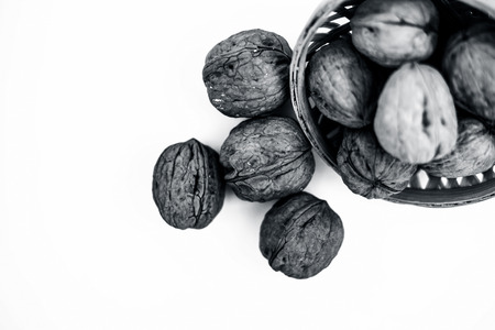 Close up of raw organic Walnut or Juglans or Akhrot or Akharot isolated on white in a hamper.の写真素材