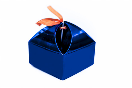 Close up of blue colored gift box isolated on white.の写真素材