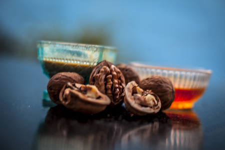 Close up of best home remedy to treat Anemia in a glass bowl on wooden surface consisting of walnut powder and raw organic honey.の写真素材