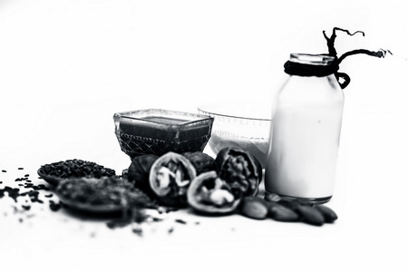 Close up of face mask or face pack of walnut along with flax seed or alsi, almonds,yogurt and milk in a glass bowl   entire raw ingredients isolated on white.の写真素材