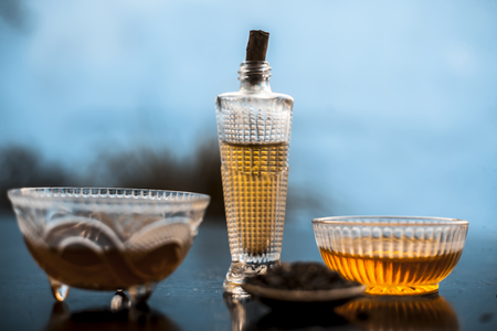 Close up of hair growth treatment on wooden surface i.e.Shikakai well mixed with honey olive oil and water on white surface with all the ingredients.;の写真素材