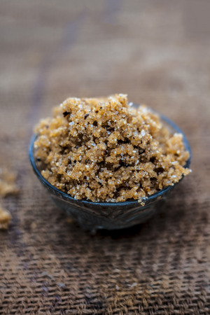 Close up of popular Indian & Asian sweet dish i.e. Malida or churma na ladu or moti chur na ladu in a bowl on brown surface.の写真素材