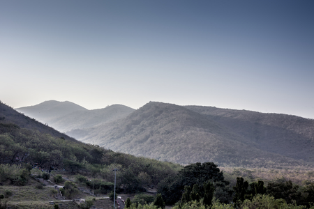 Landscape shot or view of mountains in the early morning with sunlight and flair over it.の写真素材