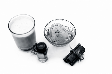 Close up of popular Indian & Asian winter drink isolated on white i.e Honey milk or shahad ka dudh in a transparent glass with entire ingredients which are milk,honey, and dry fruits.の写真素材