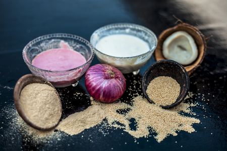 Home remdey to cure dry cough and cold on wooden surface i.e.  Poppy seeds or khus khus well mixed with onion pulp and coconut milk.Entire ingredients on wooden surface.の写真素材