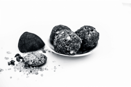 Close up of popular Indian & Asian sweet dish i.e. Malida or churma na ladu or moti chur na ladu in a glass plate with entire ingredients including fry fruits isolated on white.;の写真素材