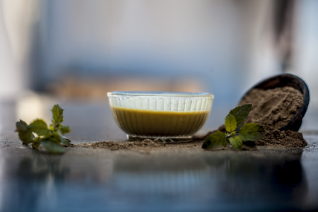 Ayurvedic herb brahmi or Waterhyssop with its beneficial paste ina  glass bowl along with its powder on wooden surface.の写真素材