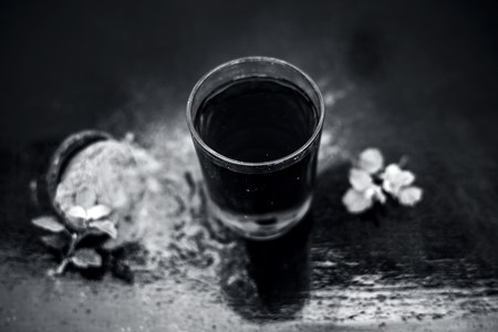 Ayurvedic herb brahmi or Waterhyssop with its herbal and beneficial extract  in a transparent glass along with its powder on wooden surface.の写真素材