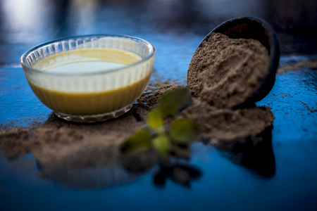 Ayurvedic herb brahmi or Waterhyssop with its beneficial paste ina  glass bowl along with its powder on wooden surface.の写真素材