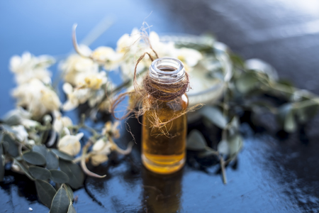 Herbal and floral essence or concentration of drumstick flowers along with its paste on wooden surface.の写真素材