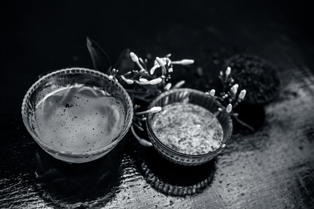 Ayurevidic face pack of Indian jasmine in a glass bowl on wooden surface i.e. jasmine extract well mixed with sandal wood powder and water.Used for skin lightening purposes.の写真素材