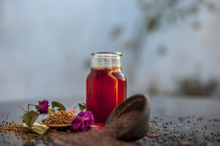 Best remedy for effective exfoliation of skin on wooden surface i.e. mustard seeds oil well mixed with rose oil. Entire raw ingredients on surface.の写真素材