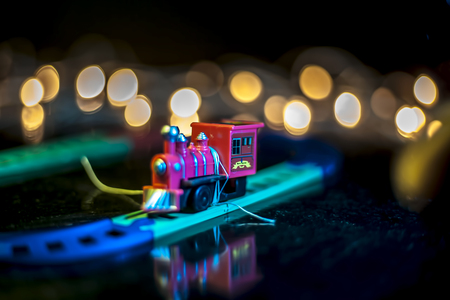 Miniature toys isolated on wooden surface with bokeh background or effect.