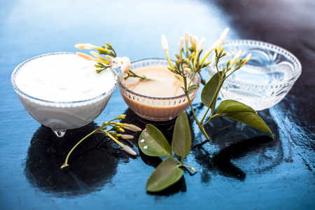 Ayurevidic face pack of Indian jasmine in a glass bowl on wooden surface i.e. jasmine Petals well mixed with milk cream & water. Used for skin whitening purposes.の写真素材