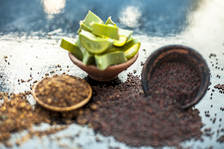 Best hair remedy to reduce hair fall and   effective exfoliation of skin on wooden surface i.e. Mustard seeds oil well mixed with aloe vera gel and entire ingredients.の写真素材
