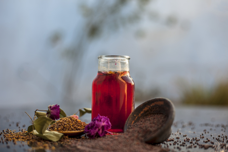Best remedy for effective exfoliation of skin on wooden surface i.e. mustard seeds oil well mixed with rose oil. Entire raw ingredients on surface.の写真素材