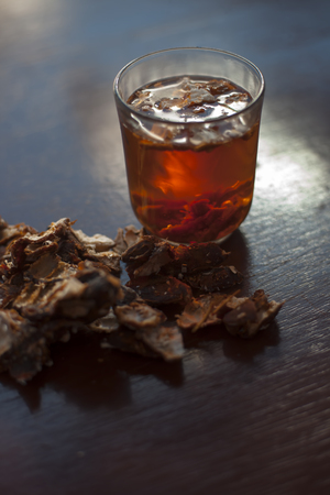 Raw organic ripe imli or amli or tamarind in a clay bowl with its organic extracted pulp in a transparent glass bowl.の写真素材
