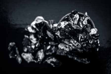 Raw peeled tamarind or imli in a clay bowl on wooden surface.の写真素材