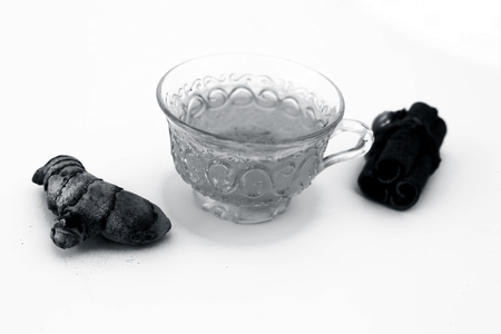 Popular turmeric tea isolated on white with its entire ingredients which are turmeric powder and raw, honey and cinnamon sticks.Used for detoxifying body.Isolated on white.の写真素材