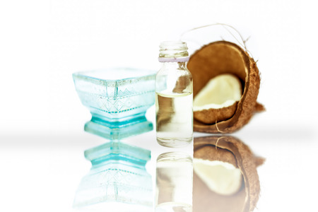 Best home remedy to reduce premature greys isolated on white i.e. Coconut oil well mixed with lemon juice in a glass bowl with entire raw ingredients.の写真素材