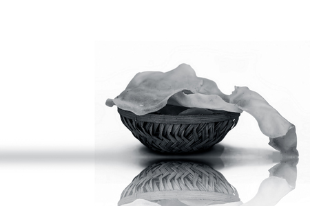 Papad or papadum in a clay bowl isolated on white with its reflection.の写真素材