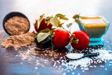 Face pack of hing or Asafoetida on wooden surface i.e. Hing powder well mixed with tomato pulp and sugar.For the treatment of skin whitening,.All the ingredients present on the surface.の写真素材