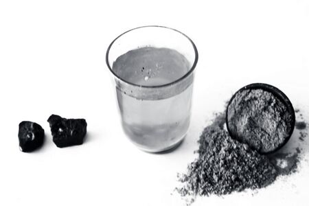 Home remedy to reduce headache or to treat headache isolated on white i.e. Hing or Devil's dung powder well mixed in water.の写真素材