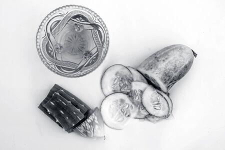 Raw cucumber along with some aloe vera gel well mixed in a glass bowl isolated on white entire ingredients.Used to rejuvenate your skin and for instant glow.の写真素材