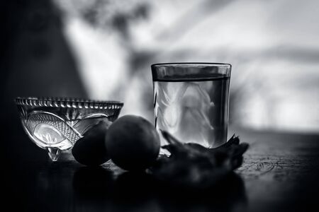Herbal detoxifying aloe vera iced tea in a big transparent glass with entire ingredients which are...
