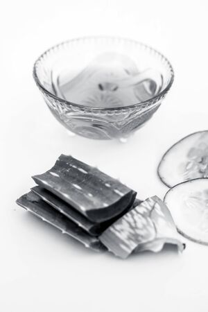 Raw cucumber along with some aloe vera gel well mixed in a glass bowl isolated on white entire ingredients.Used to rejuvenate your skin and for instant glow.の写真素材