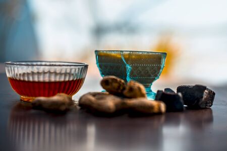 Home remedy to cure respiratory problems to a certain limit on wooden surface i.e. Suth or dried ginger well mixed with hing or honey.の写真素材