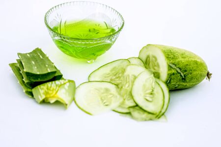 Raw cucumber along with some aloe vera gel well mixed in a glass bowl isolated on white entire ingredients.Used to rejuvenate your skin and for instant glow.の写真素材