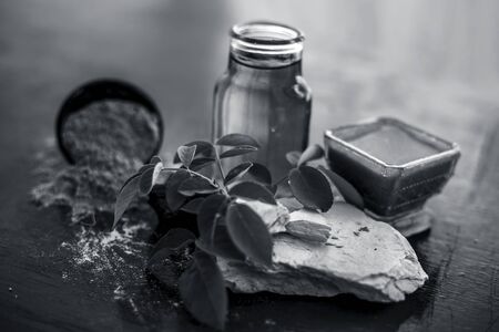 Face pack of devil's dung powder on wooden surface i.e. Hing powder well mixed with mulpani mitti or fuller's earth and rose water.Used for the treatment of Acne and pimples.の写真素材