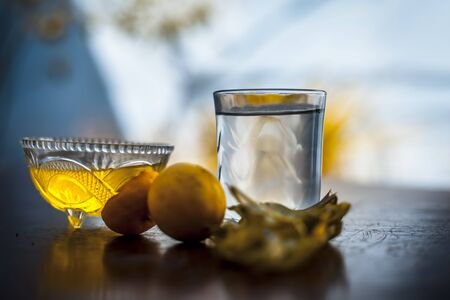 Herbal detoxifying aloe vera iced tea in a big transparent glass with entire ingredients which are...