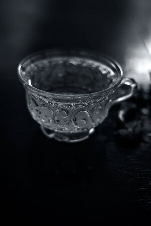 Hot herbal ayurvedic aloe vera tea on wooden surface in  transparent glass cup with entire ingredients with it.Used to build immnue system, To Lower cholesterol levels and many more.の写真素材