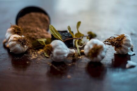 Antidote for wounds and cuts on wooden surface i.e. Devil's dung powder well mixed with garlic.Entire raw ingredients present on the surface.の写真素材
