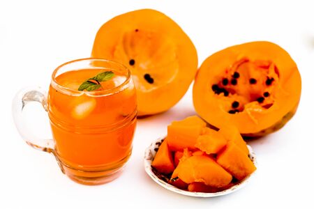 Papaya juice or smoothie isolated on white with entire ingredients which are honey,and ripe papaya.の写真素材