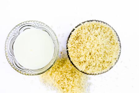 Ingredients to make popular dessert dish Kiribath made with rice and milk.The main ingredients of the dish viz. Rice and milk isolated on white.の写真素材