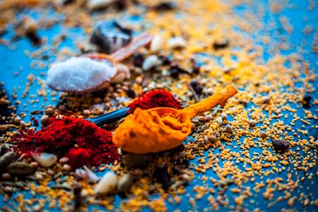 Ingredients to make mango pickle or aam ka achar or keri ka achar on black colored shiny surface.の写真素材