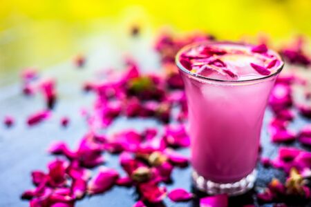 Popular Indian & Asian Summer drink on wooden surface i.e. Gulab falooda or gulab ka sherbat with...