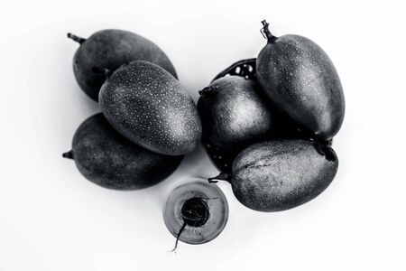 Raw organic green unripe mangoes isolated on white along with its extracted essential  oil.の写真素材