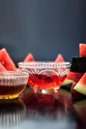 Watermelon face pack or face mask for extra soft glowing skin especially for the type of people having oily skin,Consisting of Watermelon pulp and honey well mixed in a glass bowl,Vertical shot.の写真素材