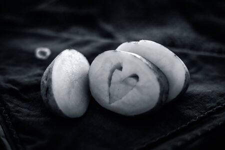 Creative shot of Potatoes with a unique cut i.e. of Heart shape in it. Concept of health care and medical along with heart, cholesterol and weight-loss by avoiding the potatoes and its products.;の写真素材