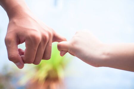 Female hand trying to conquer her fears and obstacles by holding maleâ€™s hand. Concept of...