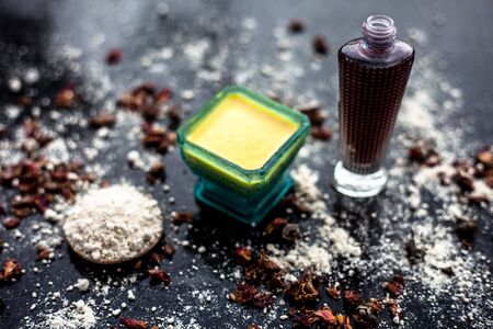 Face mask for skin whitening on wooden surface consisting of besan or gram flour and some rose...