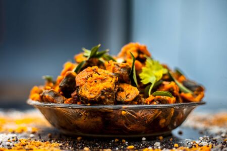 Famous Indian & Gujarati snack dish in a glass plate on wooden surface i.e. Patra or paatra consisting of mainly Colocasia esculenta or arbi ke pan or elephant ear leaves and spices. Horizontal shot.の写真素材